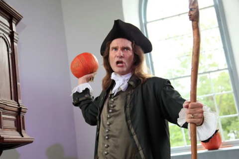 Man holding pumpkin and staff