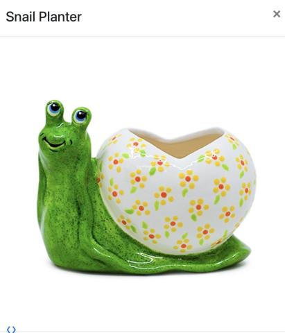 a cermaic planter in the shape of a snail. the snail is green with an off-white colored shell, with yellow flowers painted on the shell