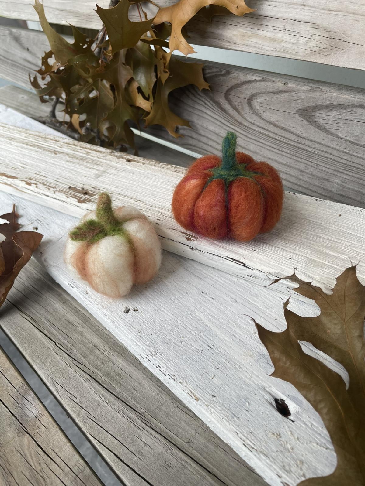 Two pumpkins, one white and the other orange