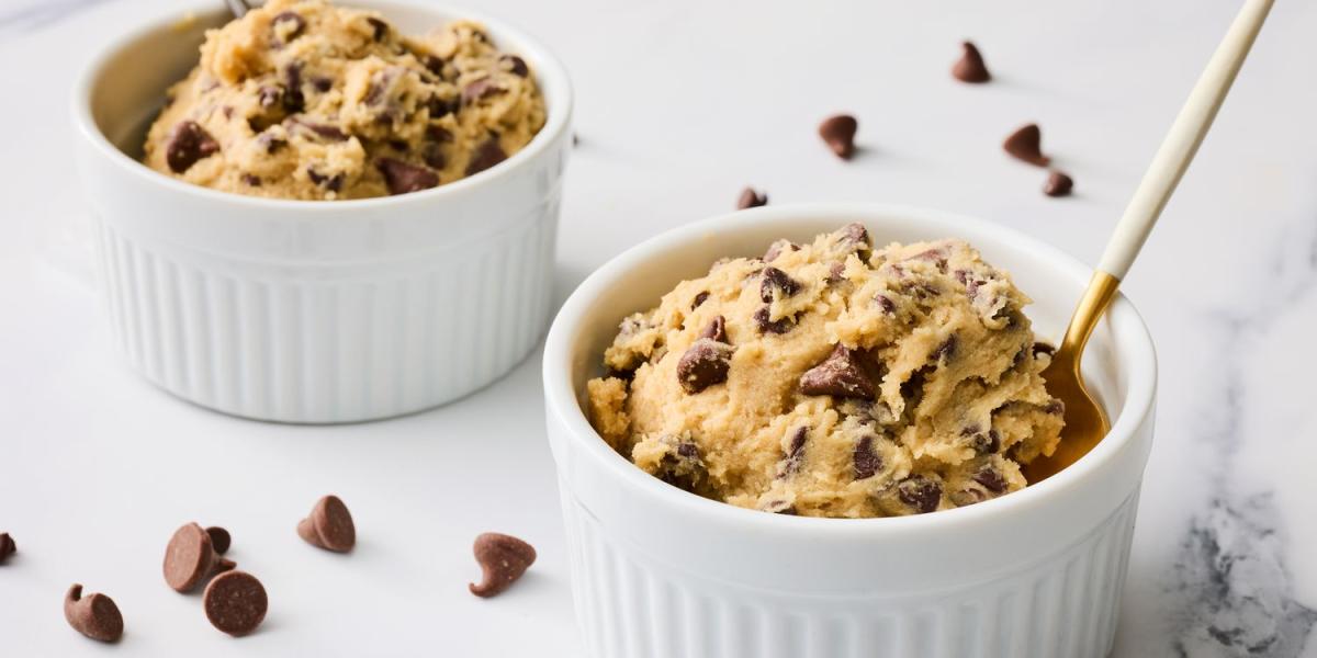 A picture of edible chocolate chip cookie dough in bowls with a spoon.